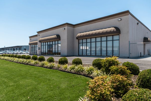 Cook's Pest Control training facility with green grass and blue sky.