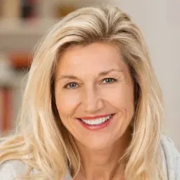 headshot of Smiling middle-aged blonde woman