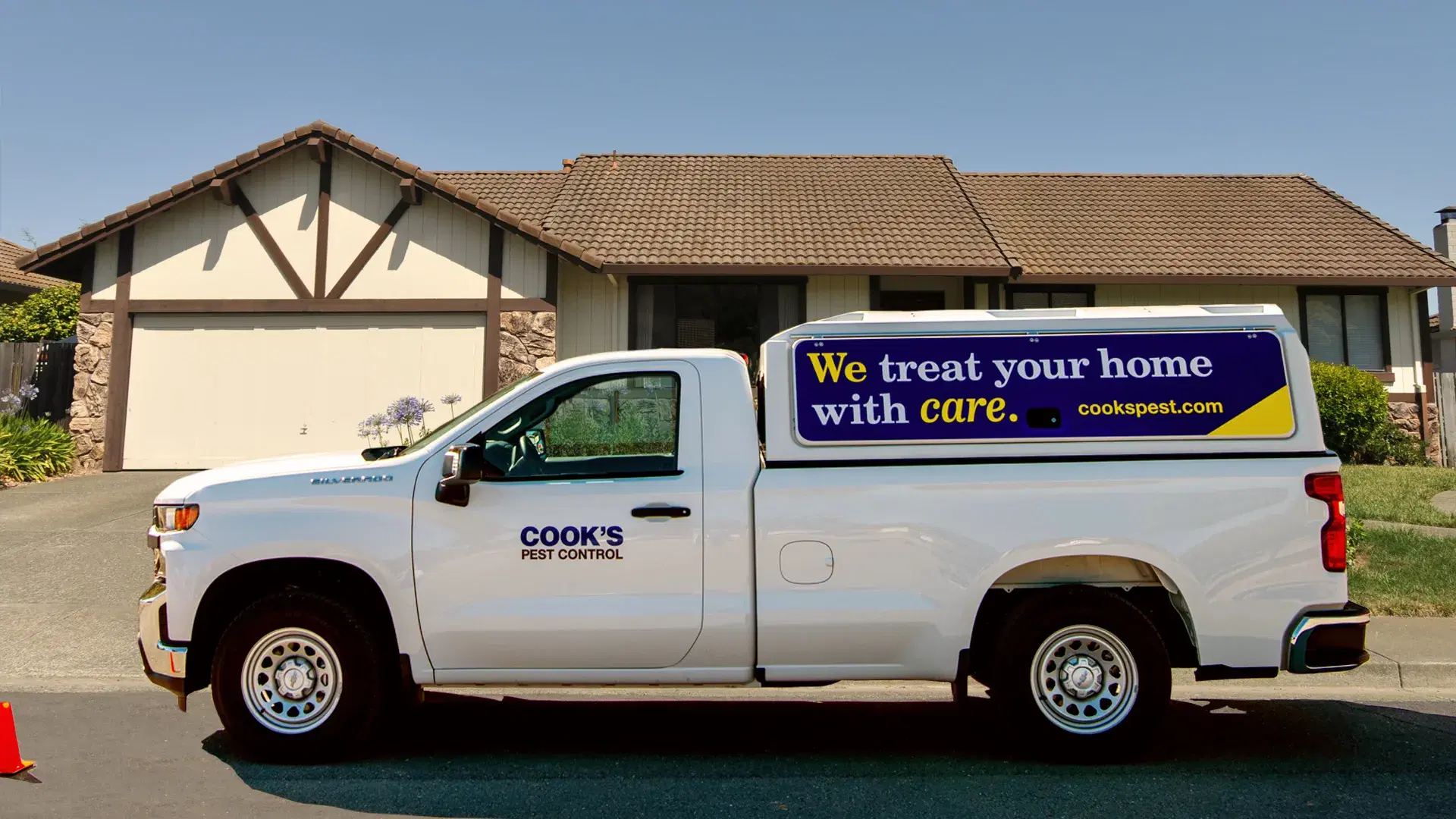 cooks pest control truck parked in front of a residential home